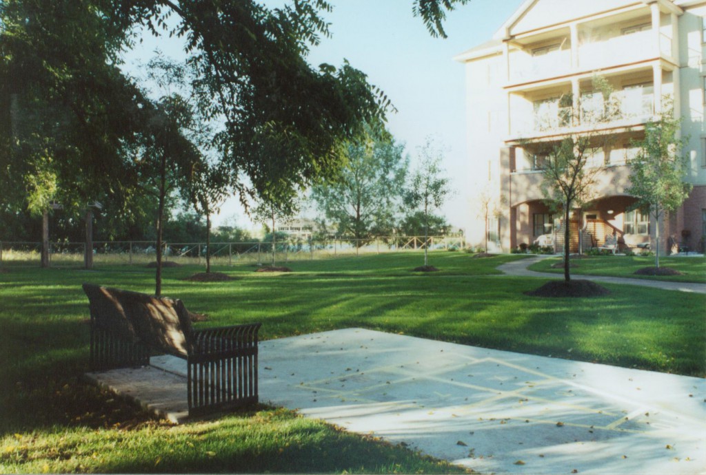 Lakeside Activities <br> The grounds were designed to provide opportunities to linger and socialize in the open air of this lakeside community.  Gardening plots are spread throughout the gardens.  A bocce court offer formalized gaming.  Walkways of various slopes and challenges encourages the physically marginal to exercise.